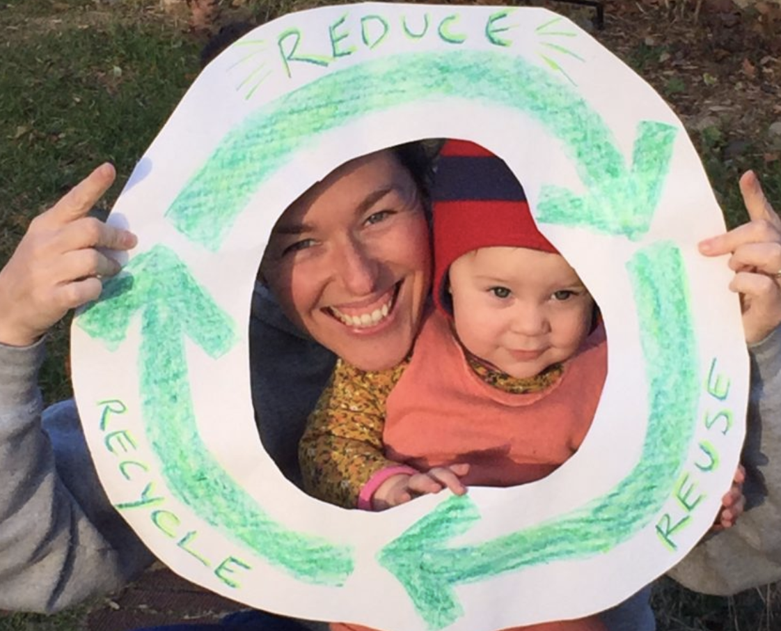 A mom and child with a recycling logo