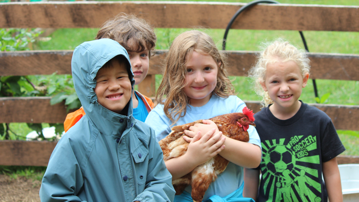 Group of campers holding a chicken