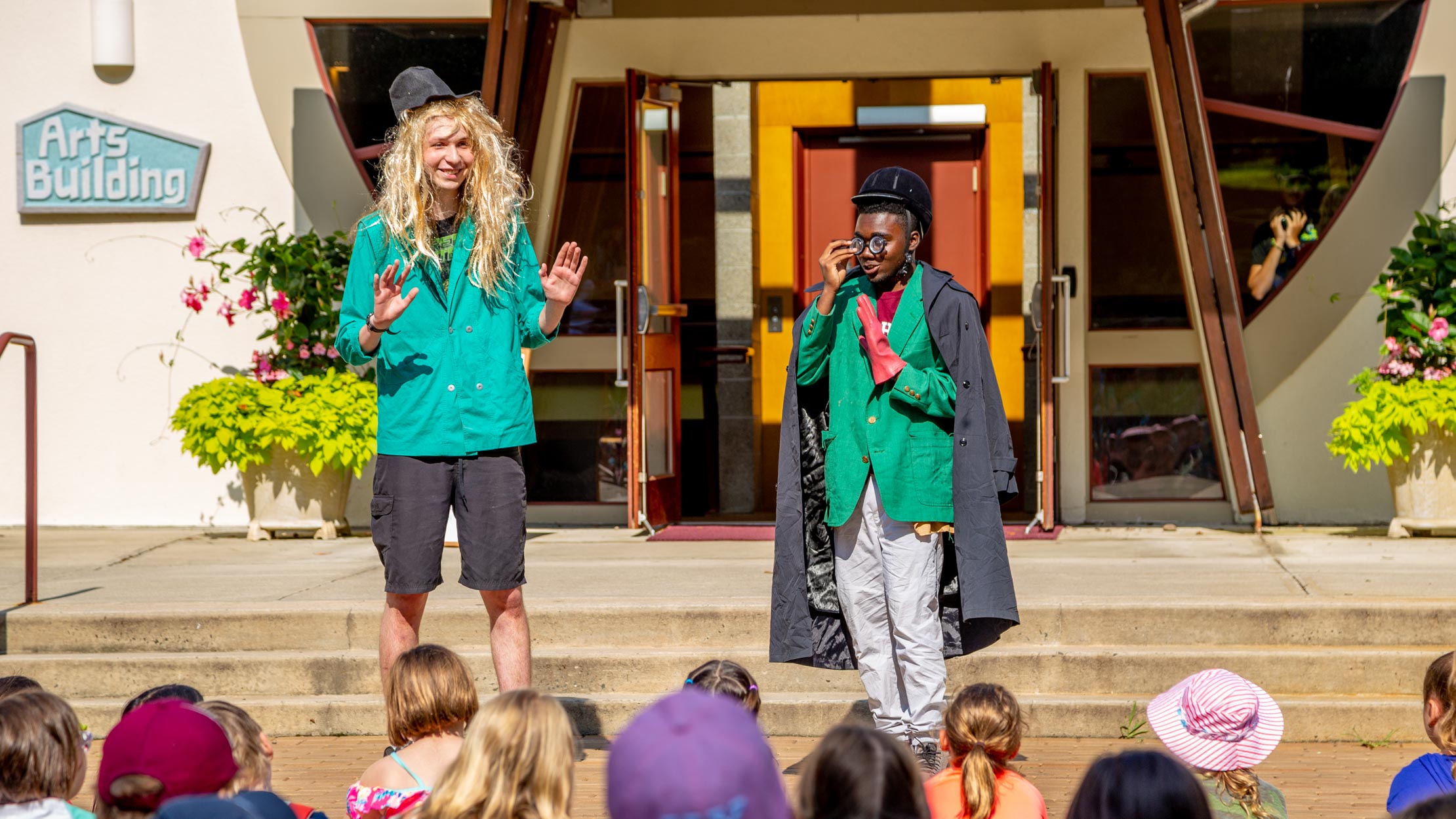 Counselors dressed up performing a skit for campers