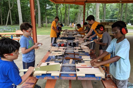 Woodworking at summer camp. Outdoor program - outside